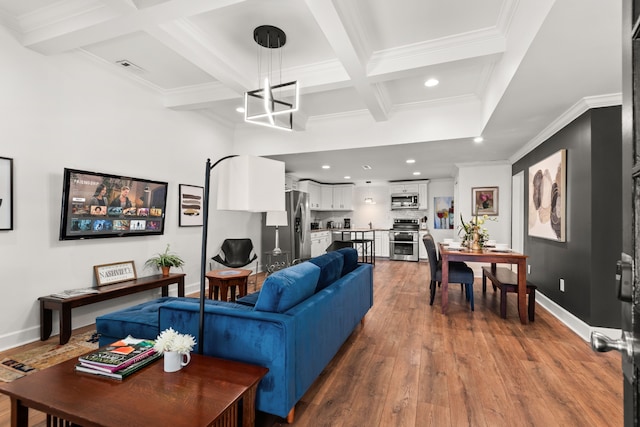 living room with hardwood / wood-style floors, coffered ceiling, crown molding, beamed ceiling, and a chandelier