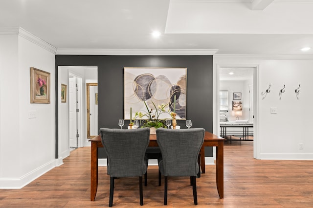 dining room featuring wood-type flooring and ornamental molding