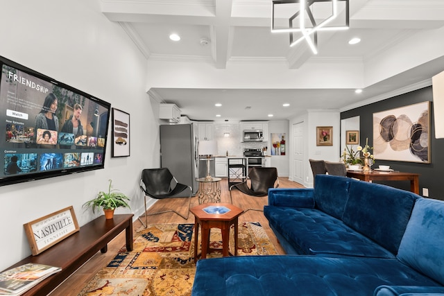 living room featuring hardwood / wood-style flooring, beamed ceiling, and ornamental molding