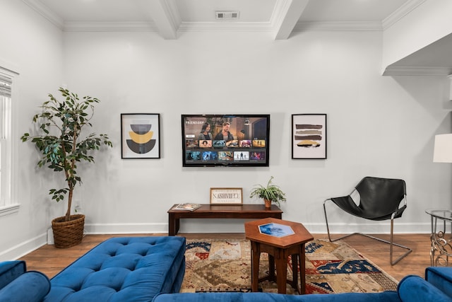 living room featuring beam ceiling, ornamental molding, and hardwood / wood-style flooring