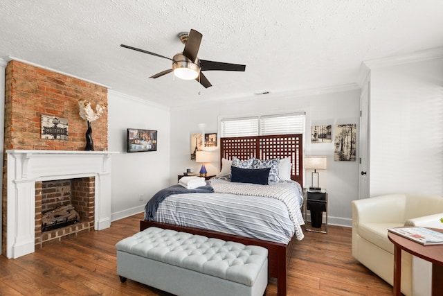 bedroom with a textured ceiling, dark hardwood / wood-style floors, ceiling fan, and crown molding