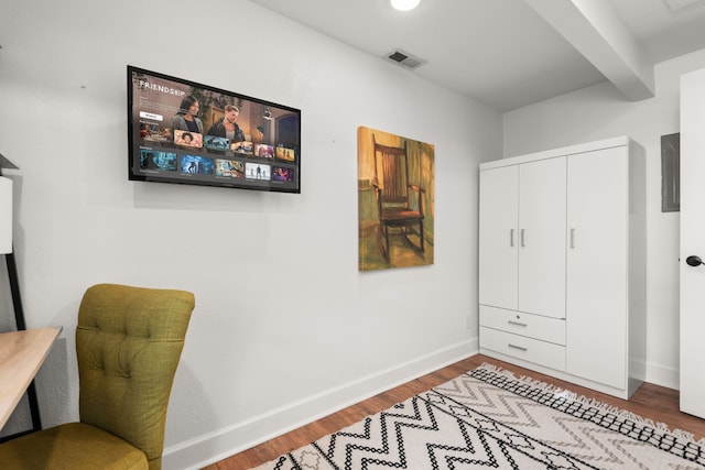 interior space featuring beamed ceiling and wood-type flooring