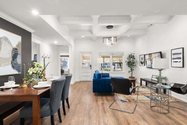 living room featuring beam ceiling, light hardwood / wood-style floors, crown molding, and coffered ceiling