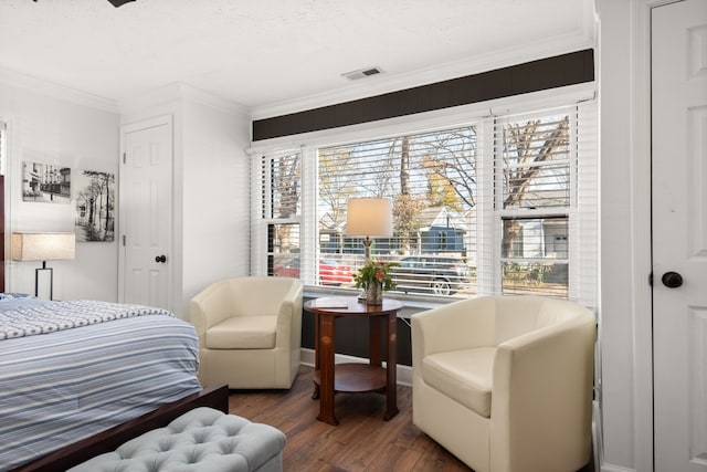 bedroom with a textured ceiling, dark hardwood / wood-style flooring, multiple windows, and crown molding