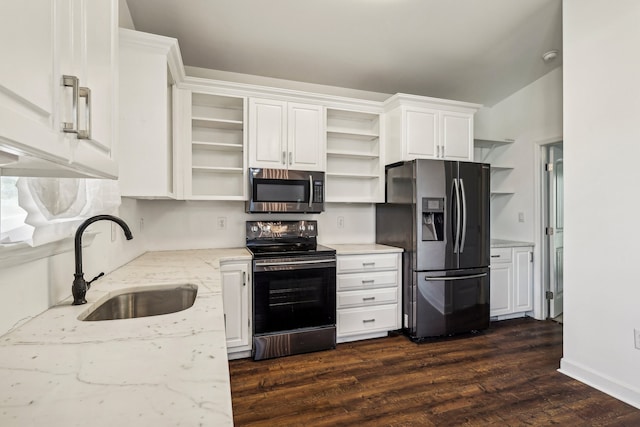 kitchen featuring dark hardwood / wood-style flooring, stainless steel appliances, vaulted ceiling, sink, and white cabinetry