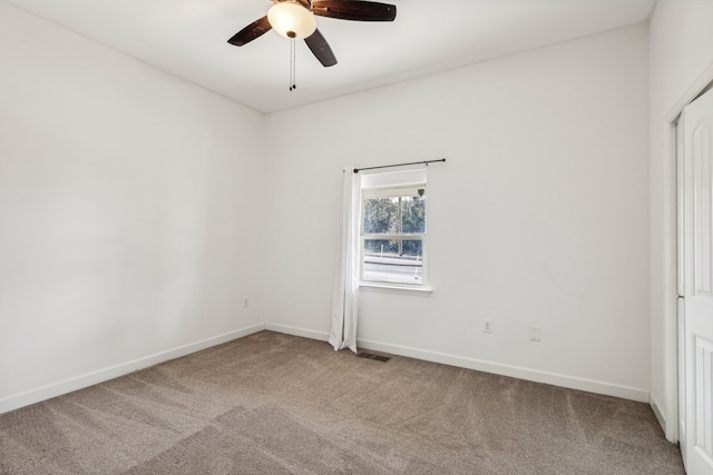 spare room with carpet floors and ceiling fan