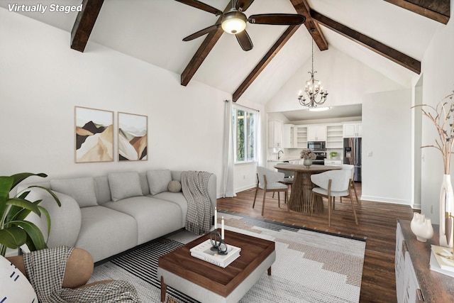 living room with ceiling fan with notable chandelier, dark wood-type flooring, sink, beam ceiling, and high vaulted ceiling