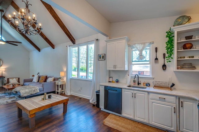 kitchen with stainless steel dishwasher, lofted ceiling with beams, sink, and a wealth of natural light