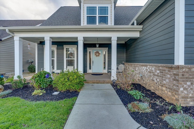 view of exterior entry featuring a porch