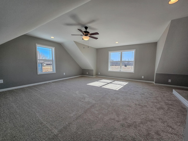 additional living space featuring lofted ceiling, carpet floors, and a wealth of natural light