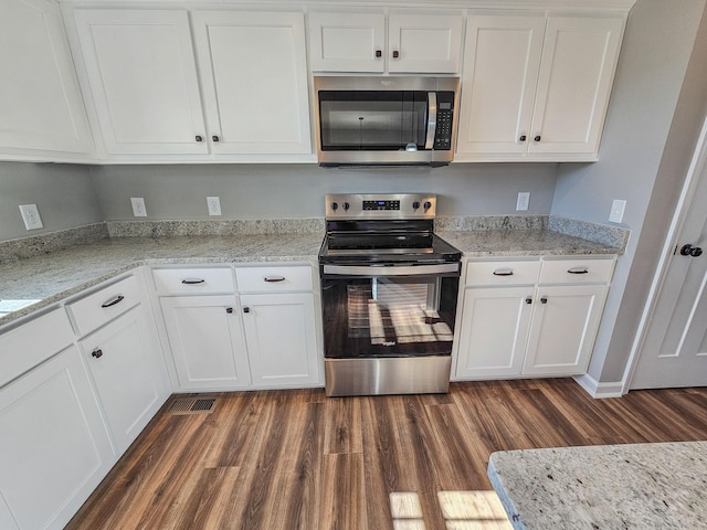 kitchen featuring appliances with stainless steel finishes, dark hardwood / wood-style floors, and white cabinets