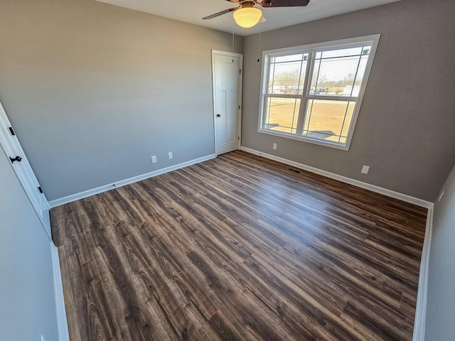 unfurnished room featuring dark hardwood / wood-style floors and ceiling fan