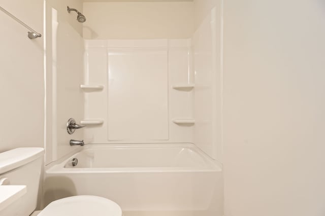 bathroom featuring washtub / shower combination and toilet