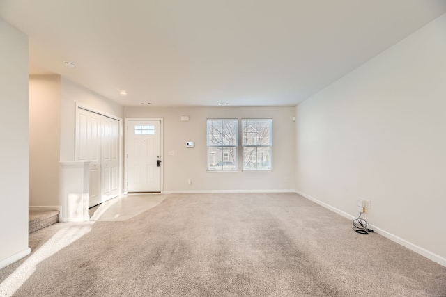 interior space with stairway, recessed lighting, baseboards, and light colored carpet