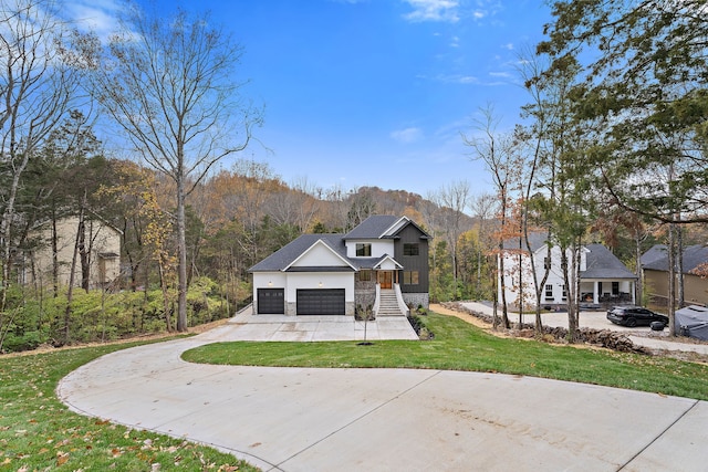 view of front of house featuring a front yard and a garage