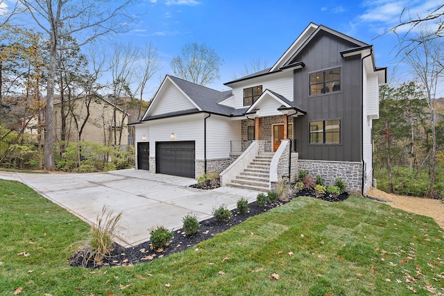 view of front of home with a front yard and a garage