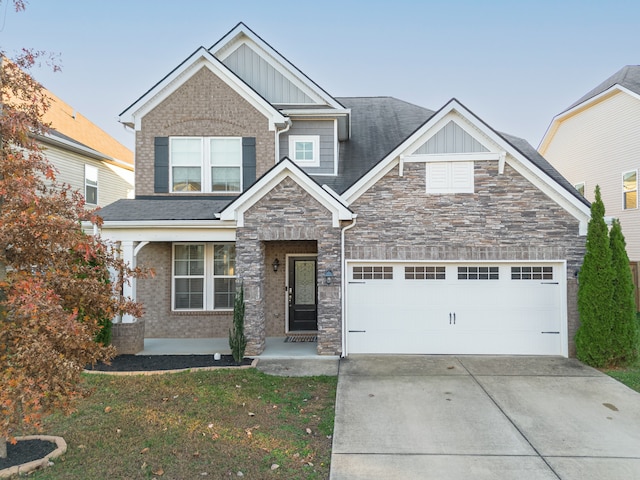 craftsman inspired home featuring a garage and a front yard