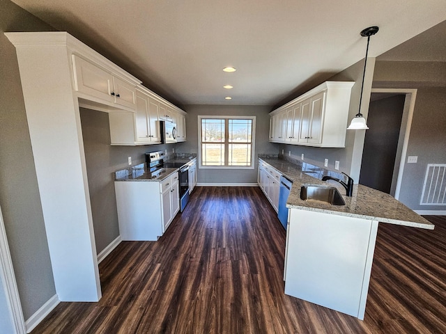 kitchen featuring appliances with stainless steel finishes, pendant lighting, white cabinetry, sink, and kitchen peninsula