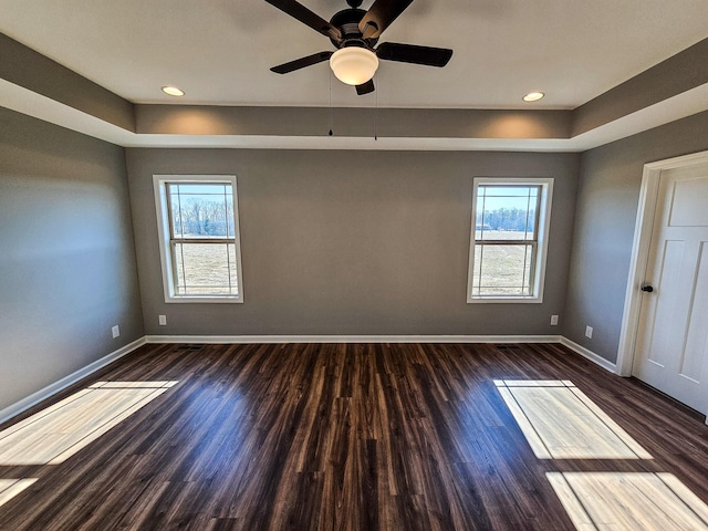 spare room with plenty of natural light, dark hardwood / wood-style floors, and ceiling fan