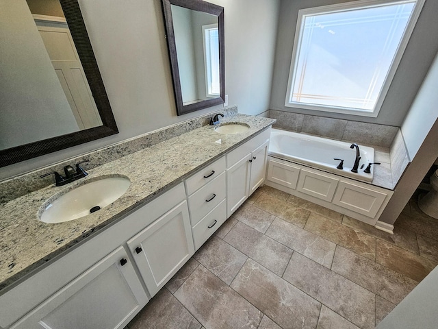 bathroom with vanity and a bath