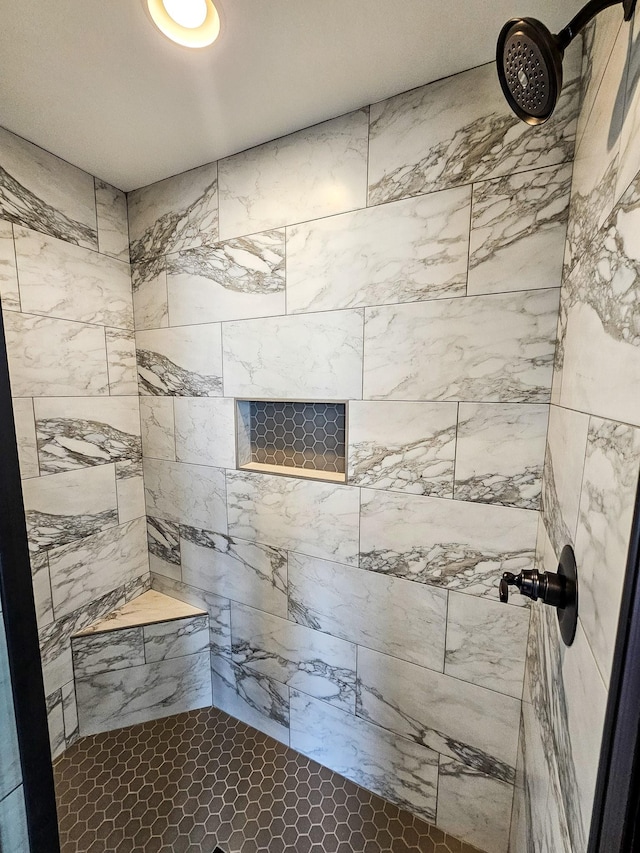bathroom with a tile shower