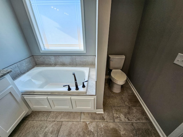 bathroom with vanity, a bathtub, and toilet