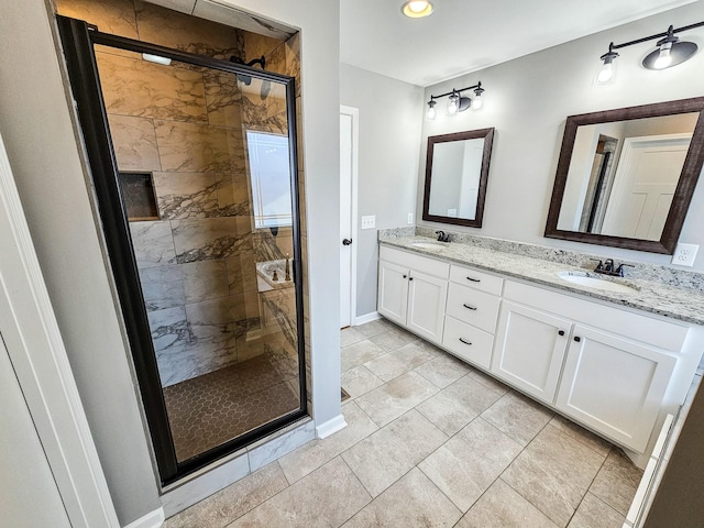 bathroom featuring tile patterned floors, vanity, and a shower with shower door