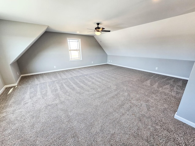 additional living space featuring carpet, lofted ceiling, and ceiling fan