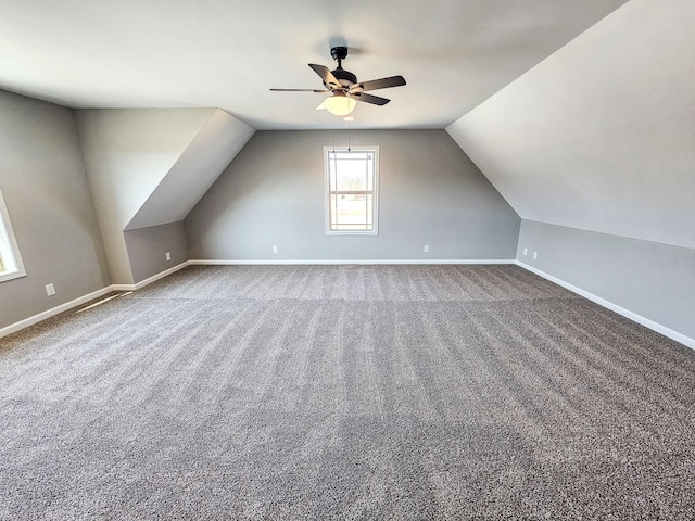 additional living space with vaulted ceiling, carpet floors, and ceiling fan