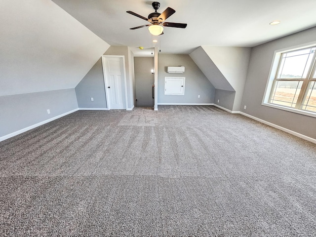bonus room with vaulted ceiling, carpet floors, a wall unit AC, and ceiling fan