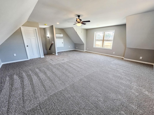 bonus room featuring vaulted ceiling, carpet floors, a wall mounted AC, and ceiling fan