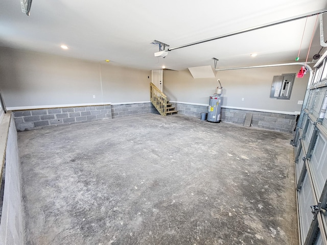 garage with a garage door opener, electric panel, and water heater