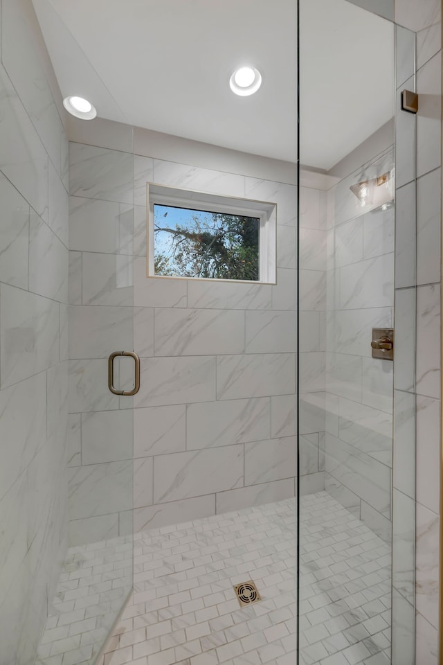 bathroom with recessed lighting and a shower stall