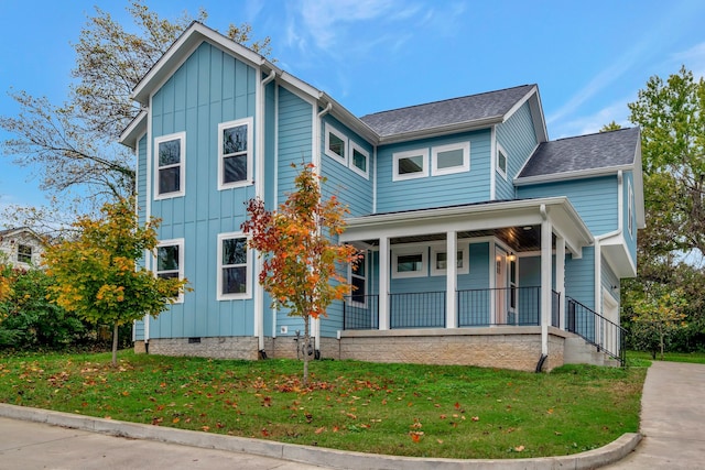 traditional home featuring crawl space, covered porch, a front lawn, and board and batten siding