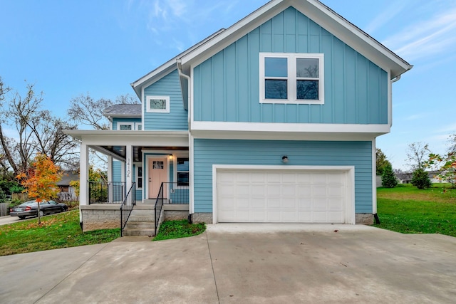 view of front facade with a front yard, a porch, and a garage