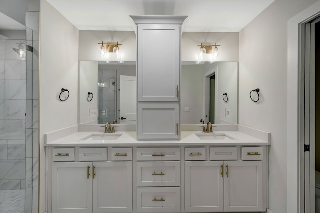 bathroom with double vanity, a stall shower, and a sink