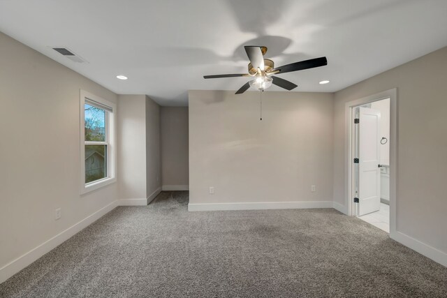 spare room with recessed lighting, light colored carpet, a ceiling fan, baseboards, and visible vents