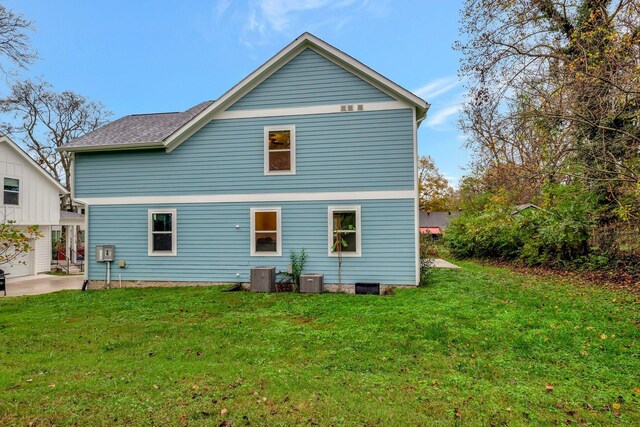 1410 Riverside Dr Unit A, Nashville, TN 37206 - back of house with a lawn, a patio, central AC unit, and roof with shingles