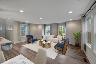 living room with baseboards, wood finished floors, and recessed lighting