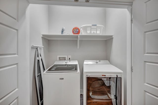 clothes washing area with washing machine and clothes dryer