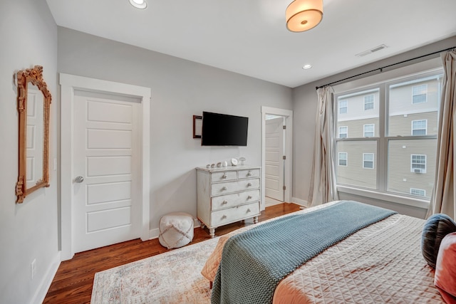 bedroom with dark hardwood / wood-style floors