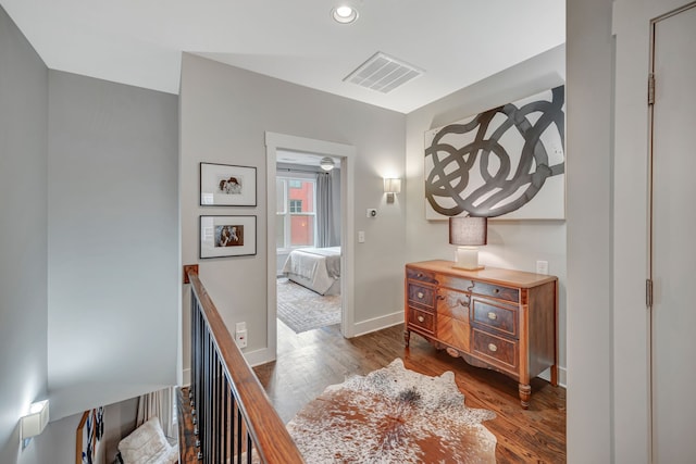 corridor with dark hardwood / wood-style flooring