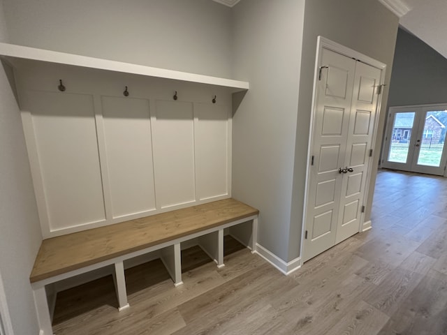 mudroom featuring french doors, ornamental molding, and light wood-type flooring