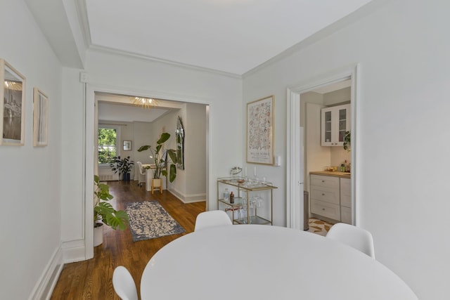 dining area featuring crown molding and dark hardwood / wood-style floors