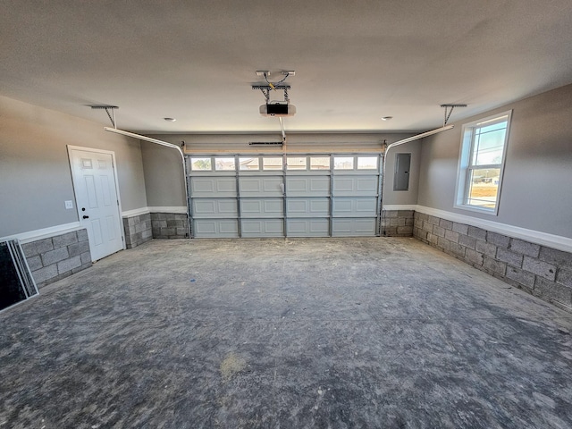 garage with a garage door opener and electric panel