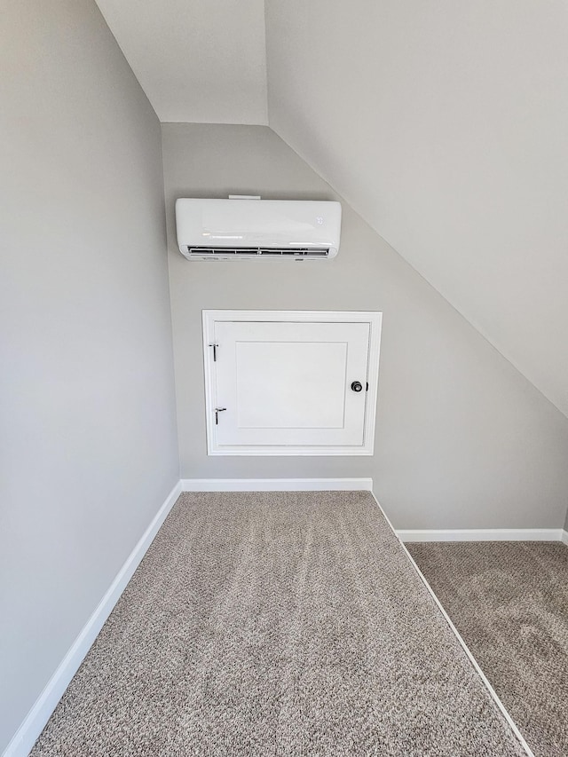 bonus room featuring vaulted ceiling, carpet flooring, and a wall mounted AC