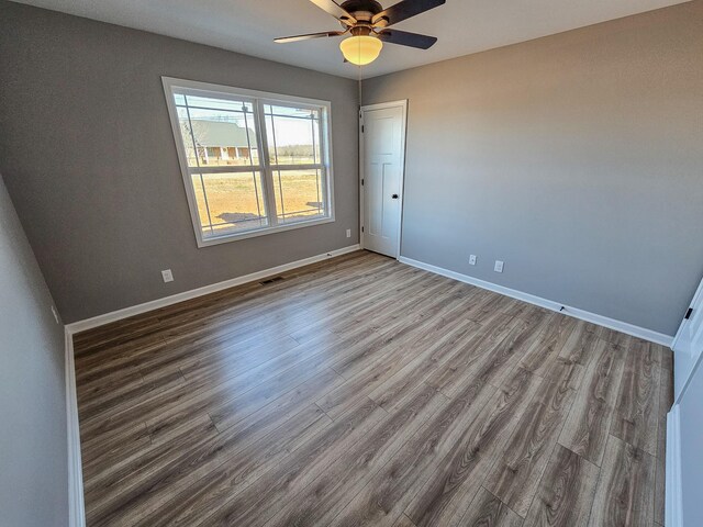 spare room with hardwood / wood-style floors and ceiling fan