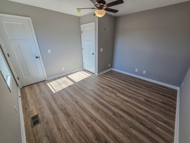 unfurnished bedroom featuring dark hardwood / wood-style floors and ceiling fan