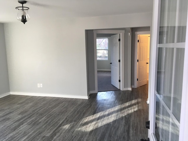 unfurnished room with dark wood-type flooring