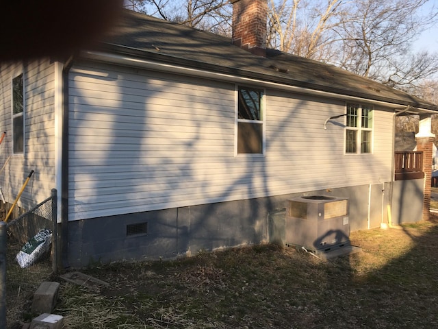 view of side of home featuring central AC unit